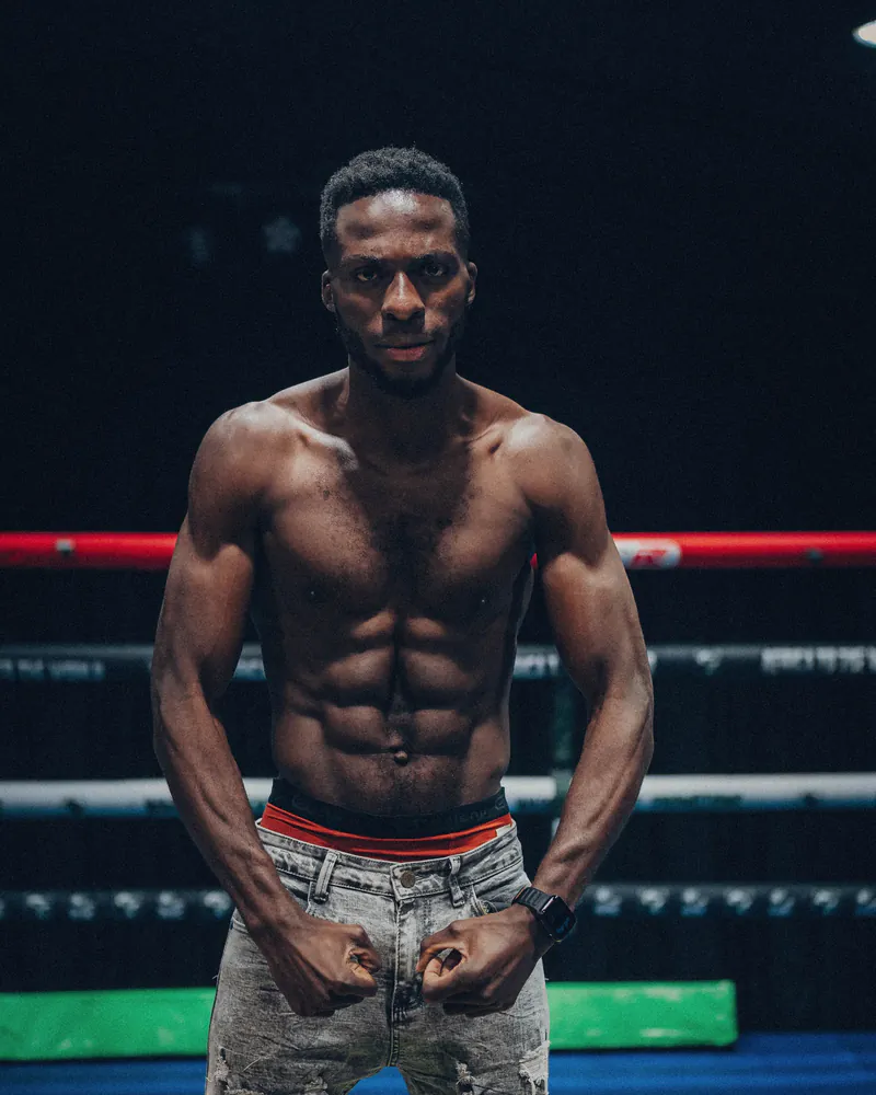 Aaron Muteba stands square to camera in a boxing ring