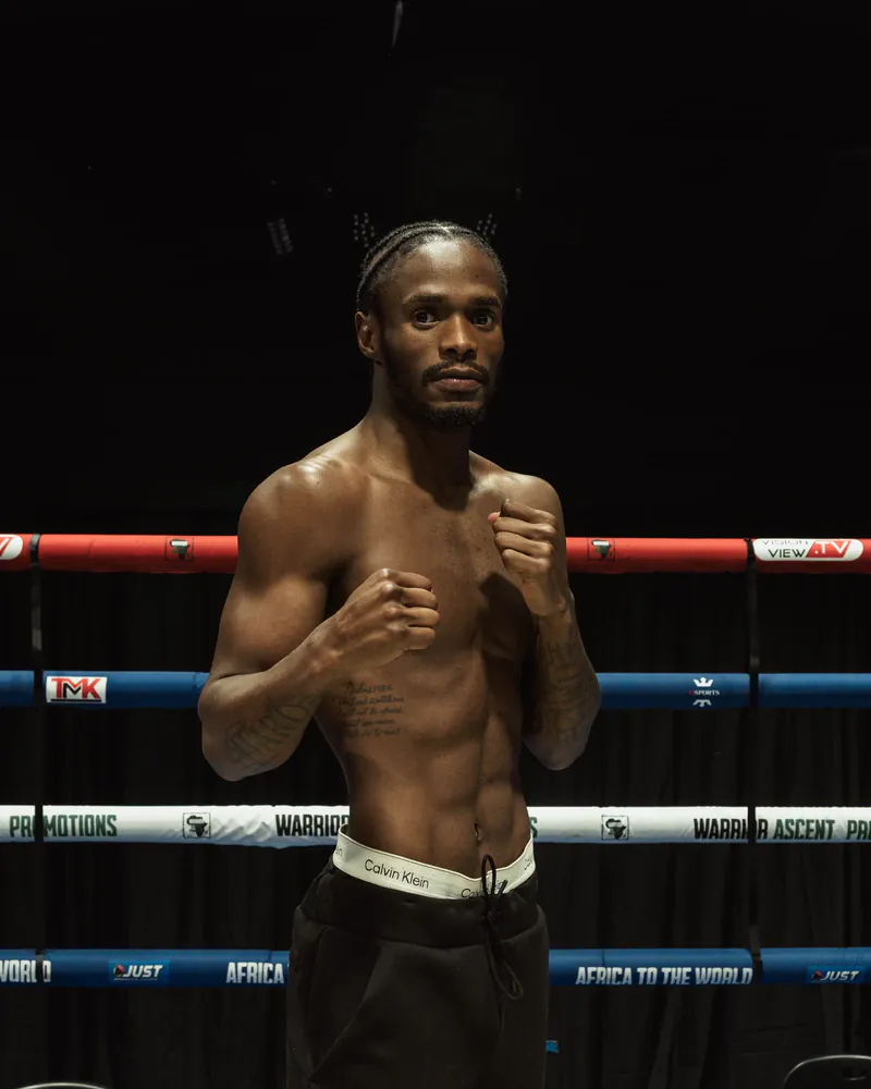 John Paul Masamba poses in a boxing stance inside the ring