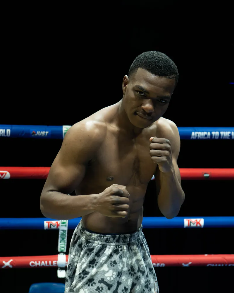 Mayamiko Mozland poses in a boxing stance inside the ring