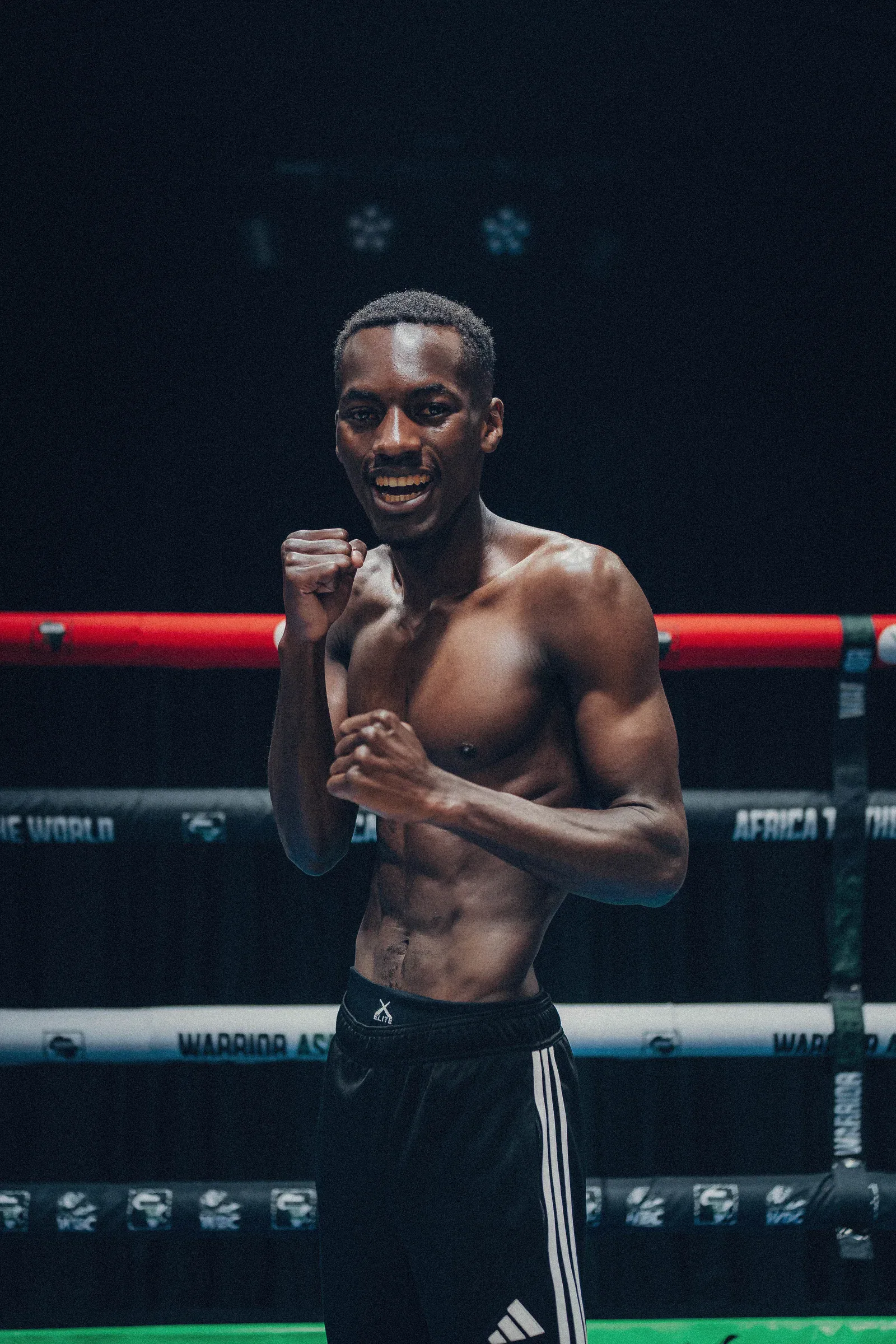 Ndabezinhle Phiri smiles in a boxing stance inside the ring
